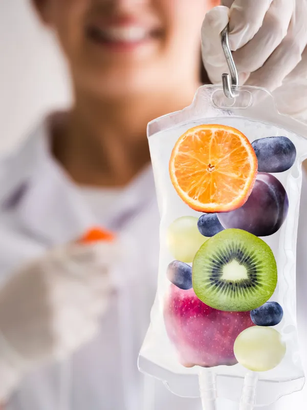 IV bags filled with fresh citrus slices, representing the vitamin C in a Myers Cocktail