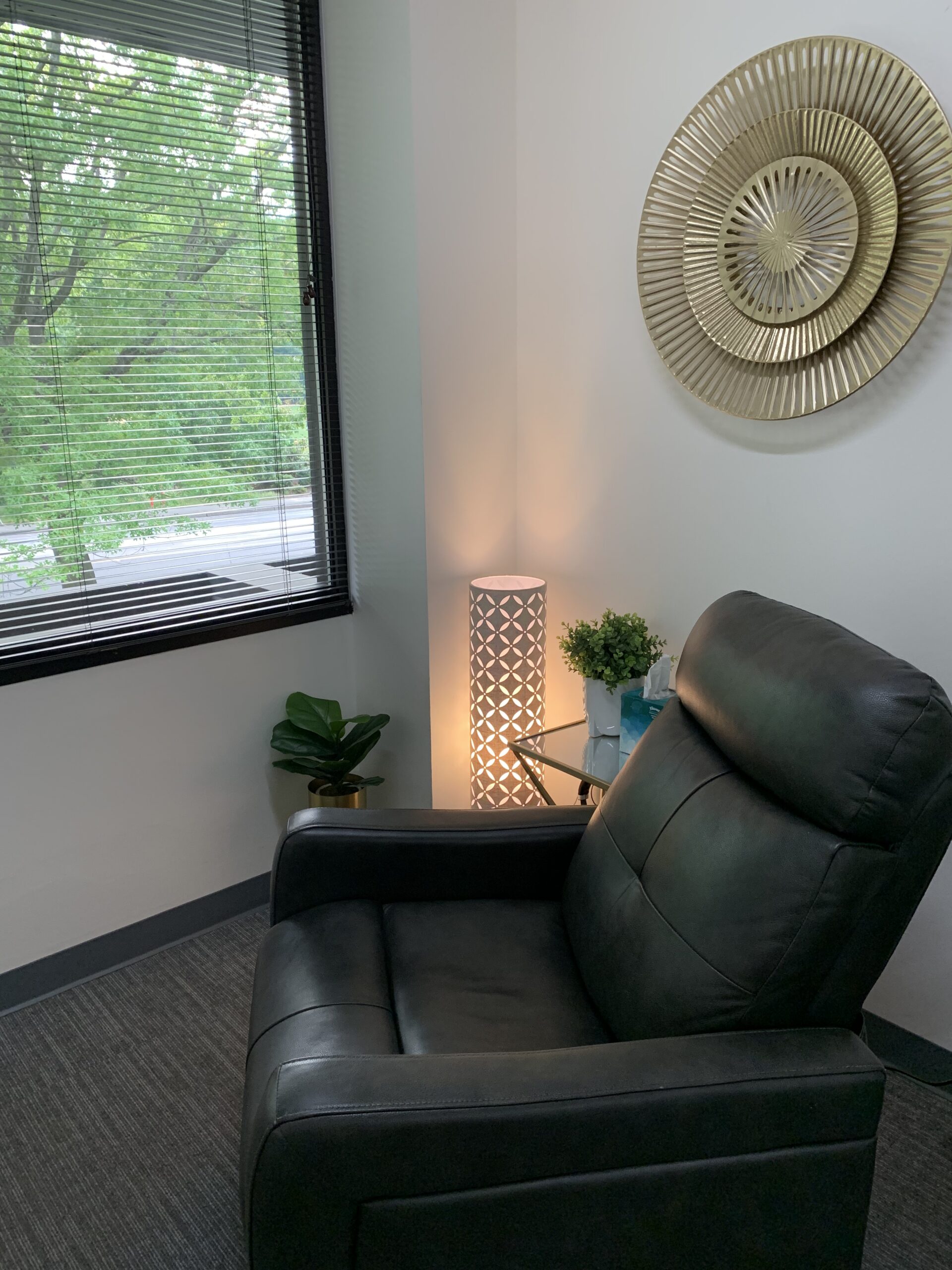 A private patient room with a treatment recliner beside a window at the Northwest Healing and Wellness clinic in Bellevue, Washington